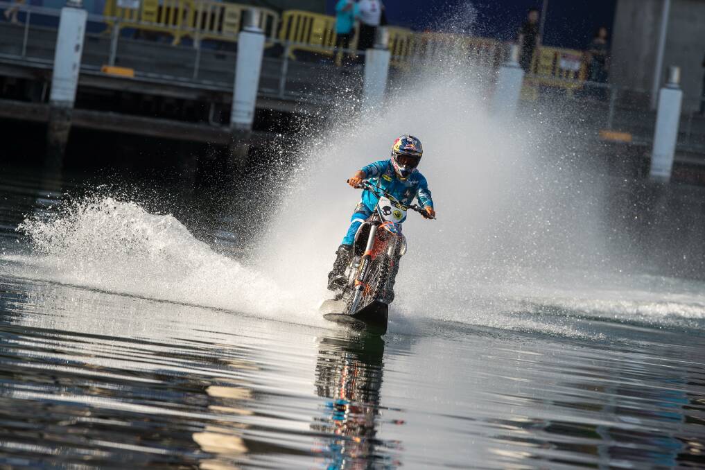 INCREDIBLE: Nowra daredevil Robbie Maddison on the water of Cockle Bay on Darling Harbour as part of the Sydney Motorcycle Show last weekend. Photo: Marc Jones Photography
