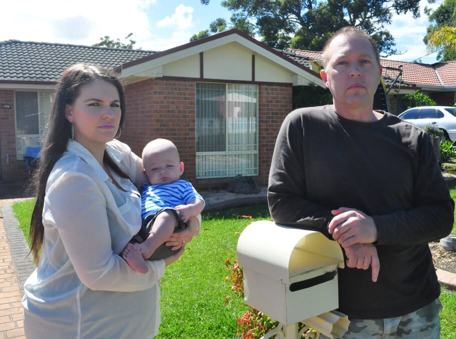 VICTIMS: Michelle and Andrew Steele with their youngest child Benjamin outside their Sanctuary Point home which has been targeted by hoodlums. Photo Damian McGill