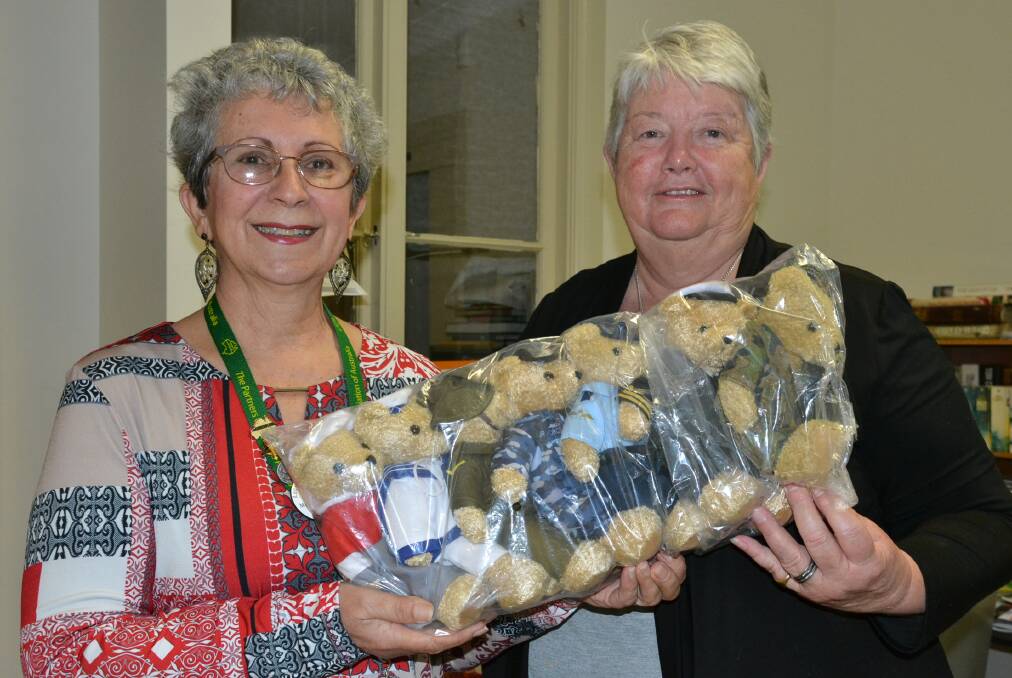 
Nowra Torchbearers For Legacy president Stenia McDonnell (left) and secretary Julie Morris with some of the merchandise that was sold during Legacy Week.
