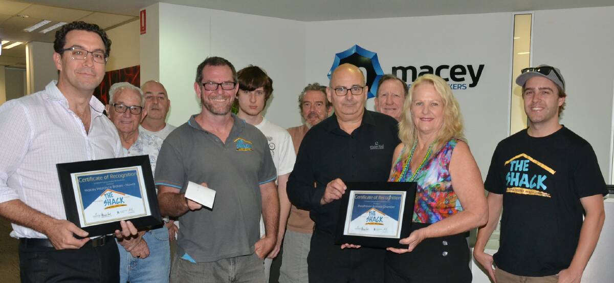 The Shack founders Brett Steele and Garry Field make a presentation to Shoalhaven Business Chamber chairman and golf day sponsor Brendan Goddard and chamber administration manager Jeni Vine watched by Shack volunteers and participants Neil Keating, Michael Bart, Aiden James. Steve Wade, Allan Steele and Jonathan Vidamour.