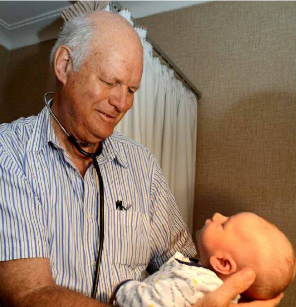 HOOLY DOOLY: Local obstetrician and gynaecologist Doctor Brian Hoolahan with another Shoalhaven new arrival, AJ Campbell. Photo: ADAM WRIGHT (Photo taken 2013)