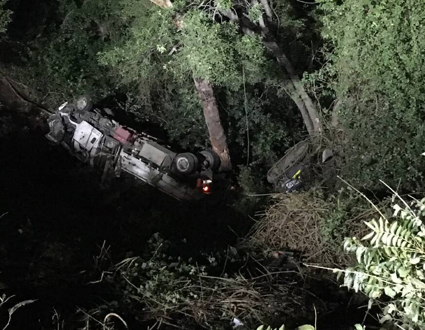LUCKY ESCAPE: The truck and excavator rolled 50 metres down the mountainside after crashing on Cambewarra Mountain on Friday, June 5.