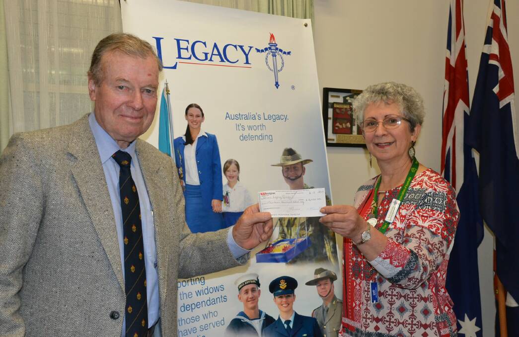 Nowra Legacy chairman Colin Cook accepts the $13,000 donation from Nowra Torchbearers For Legacy president Stenia McDonnell.
