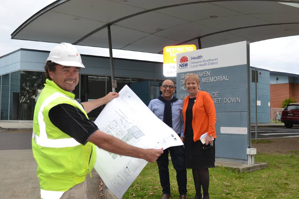 Zauner Constructions senior site manager for the ED project Drewe Timewell, change manager Albert Vasquez and director of nursing Deborah Cameron look over the plans for reconfiguration and expansion at Shoalhaven Hospital.