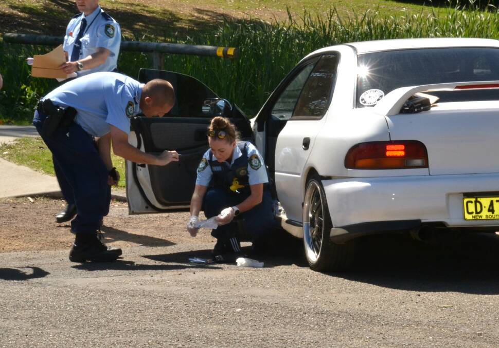 Police search the allegedly stolen Subaru Impreza after it crashed following a police pursuit in Nowra East.
