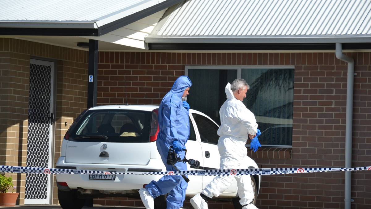 Forensic evidence: Scientific officers enter the Nowra home.
