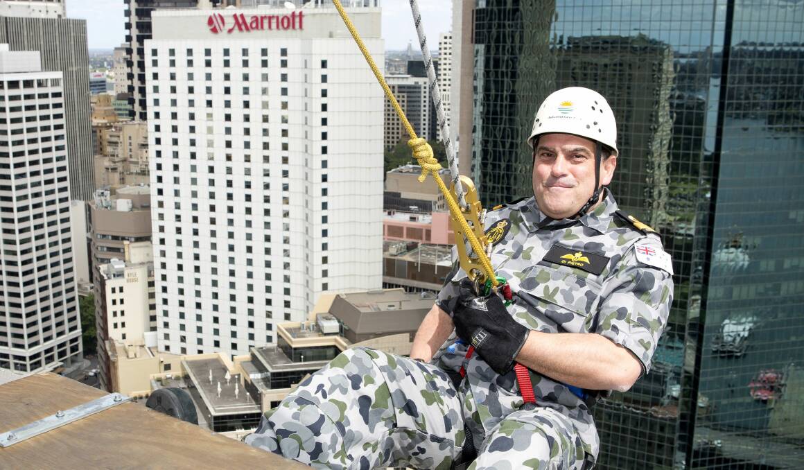 HANGING ABOUT: Commander Fleet Air Arm, Commodore Vince Di Pietro taking part in the 2013 challenge, stepping off the edge of the 26th floor of Sydney's AMP Building, raising money for the Sir David Martin Foundation. Photo: RICHARD CORDELL