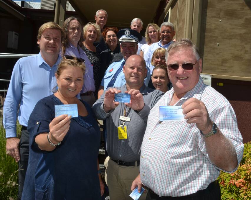 Shoalhaven Suicide Prevention and Awareness Network secretary Wendi Hobbs, member Tim Hudman and chairman Bruce Murphy and fellow SSPAN members proudly show off the group's innovative Blue Card project.