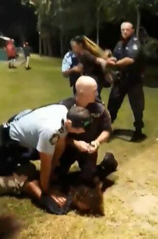Two Shoalhaven police officers restrain a youth during the Australia Day incident at Huskisson, while another is apprended by police. Image: Facebook