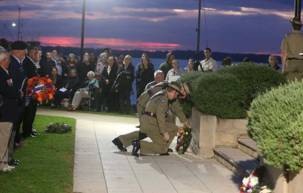 Commanding officer of the Parachute Training School, HMAS Albatross, Lieutenant Colonel Richard Bushby lays a wreath during Tuesday's Greenwell Point dawn service.