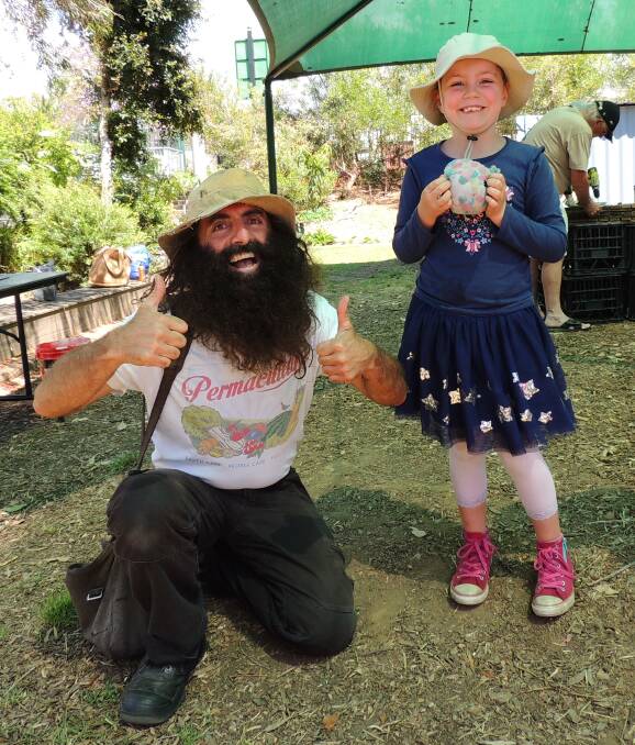 
ABC Gardening Australia host Costa Georgiadis with a young fan at the Nowra East Community Garden working bee.