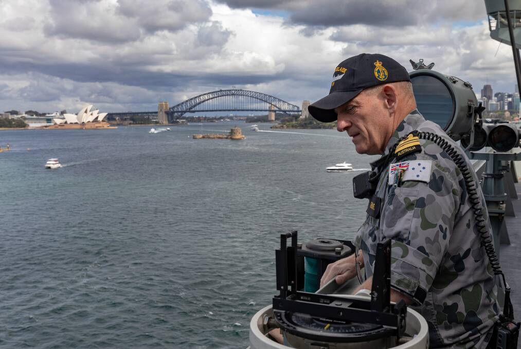 HMAS Adelaide First Lieutenant, Lieutenant Commander Sandy Jardine oversees the ships departure from Fleet Base East in Sydney as the ship sails to take part in Operation Render Safe. Photo: Christopher Szumlanski