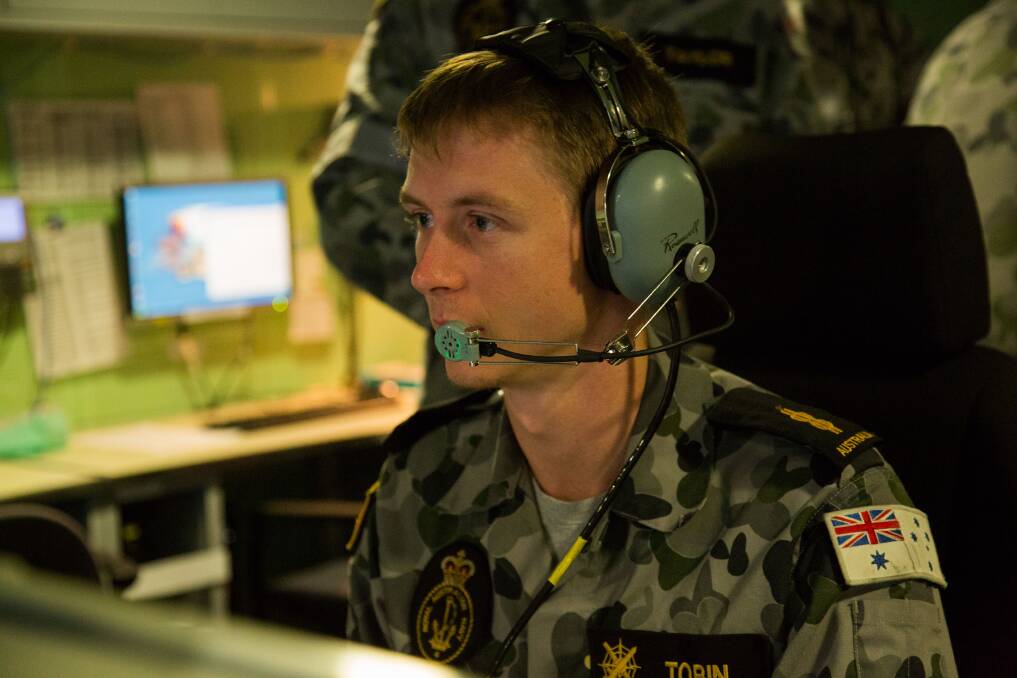 Able Seaman Combat Systems Operator Max Tobin manning the console in the Operations Room onboard HMAS Canberra during a Nulka trial as part of Exercise Ocean Explorer 2018. Photo: Tara Byrne