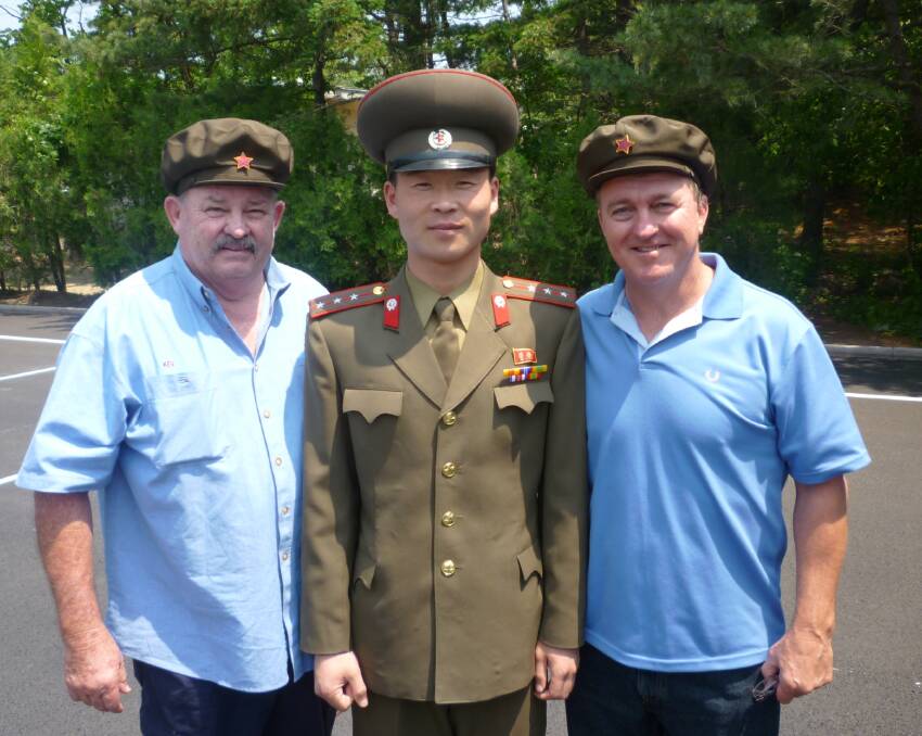 Rick Meehan (right) and a fellow tourist with a North Korean soldier.
