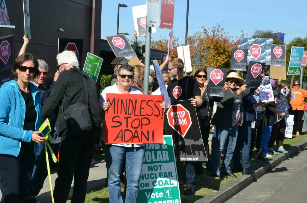 Protesters voice their opposition to the proposed Queensland Adani Coal mine at a protest in Bomaderry where treasurer Scott Morrison was attending a business luncheon.