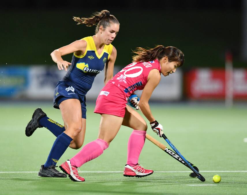 DEFENCE: Gerringong's Grace Stewart moves in to tackle Japan's Minami Shimizu during the Hockeyroos 2-1 victory and series win at the State Hockey Centre, Gepps Cross, Adelaide. Photo: AAP Image/David Mariuz