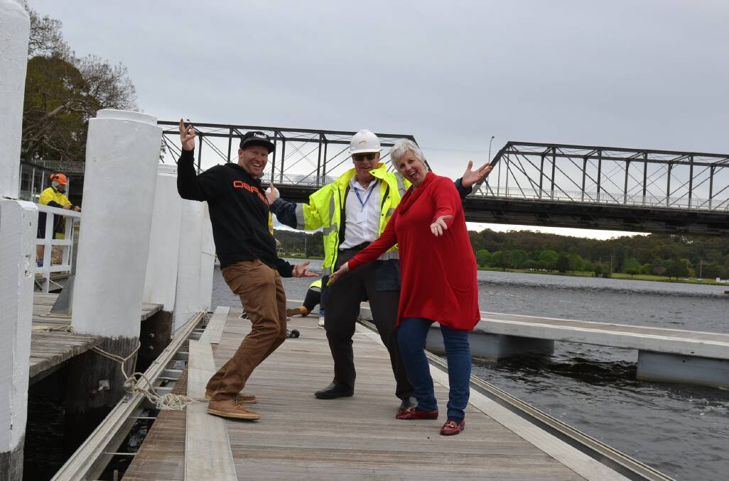 FESTIVAL TIME: Shoalhaven River Festival watersport co-ordinator Johny Vynes, Shoalhaven City Council director Corporate and Community Craig Milburn and river festival organiser Lynn Locke celebrate the arrival of the pontoons to the Shoalhaven River ahead of this week’s festival. The pontoons will remain after the event to provide the area with its first dedicated marina.