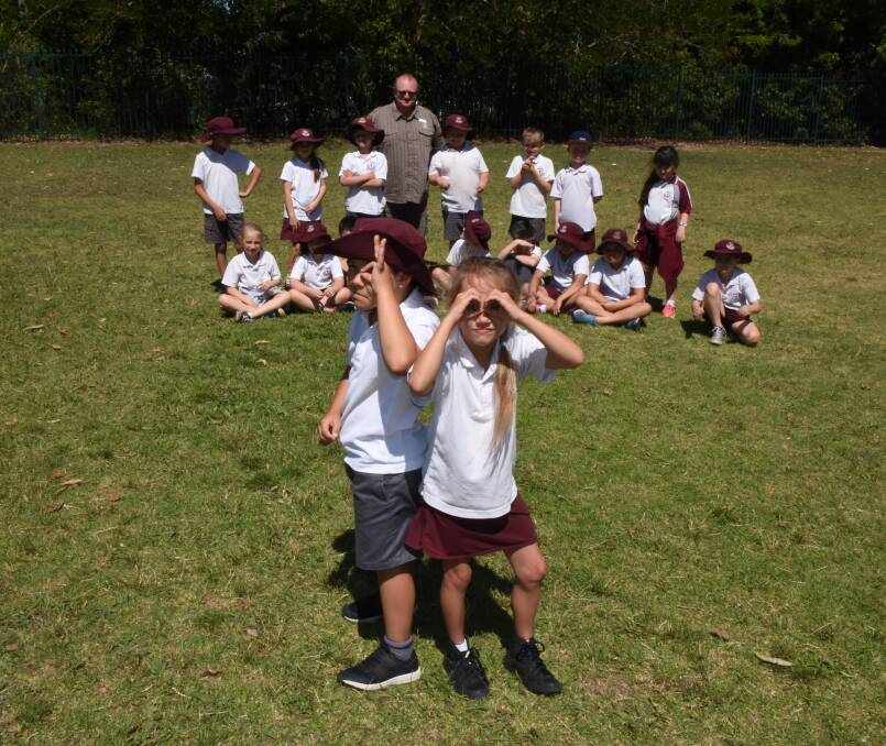 YOUNG SLEUTHS: Nowra Public 2M students Clay Almond and Charleigh Reynolds and their classmates on their playing oval where they believe the mysterious well described in Hayley Warden’s historical article in the South Coast Register is located.
