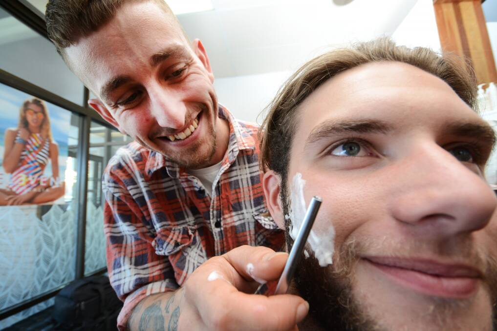 LOOK SHARP: Nowra barber Matt Whitaker sharpens up Falls Creek resident Brodie Clark’s beard.