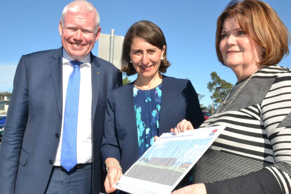 NSW Premier Gladys Berejiklian, Kiama MP Gareth Ward and  South Coast MP Shelley Hancock look over an artist's impression of the new $9.8m multi-level car park at Shoalhaven District Hospital.