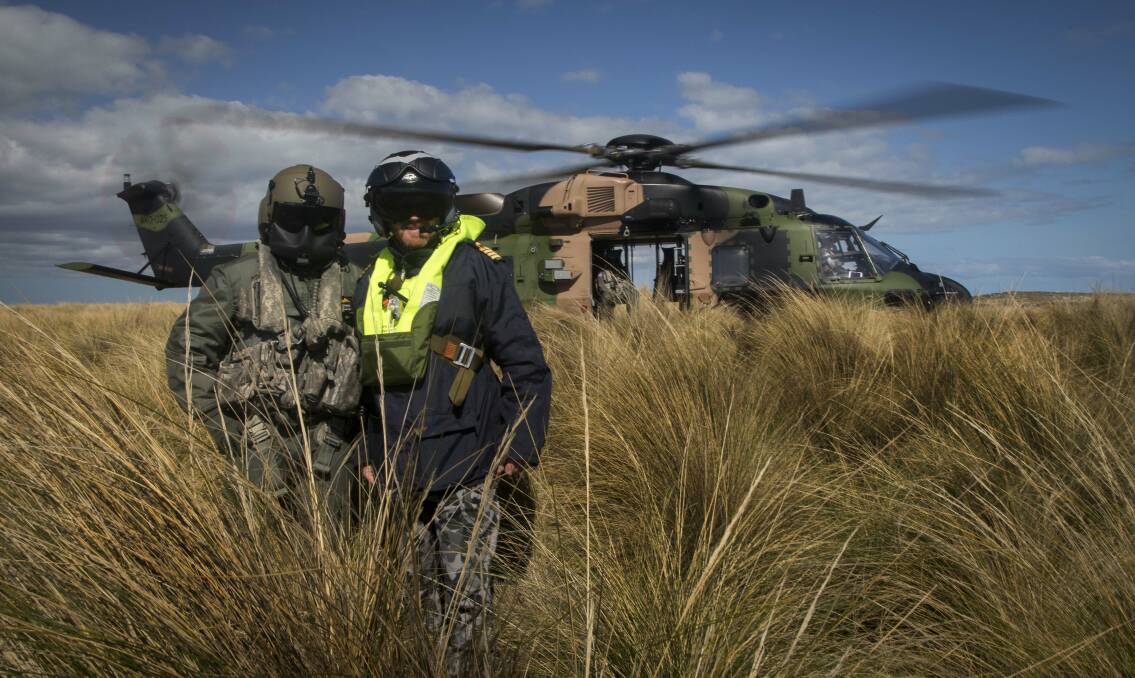 Petty Officer Aircrew Jason Wilkman and Commander Task Group, Captain Paul O’Grady in front of a MRH-90 Helicopter on Flinders Island, Tasmania, during Exercise Ocean Explorer 2018. Photo: Tara Byrne