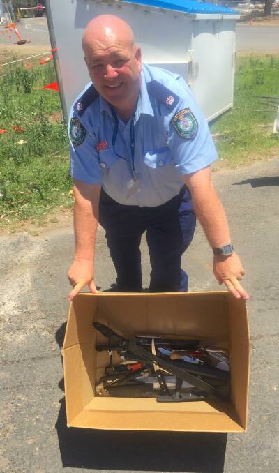 DESTROYED: Shoalhaven Police duty officer Chief Inspector Steve Johnson with the knives seized locally last year which were destroyed.
