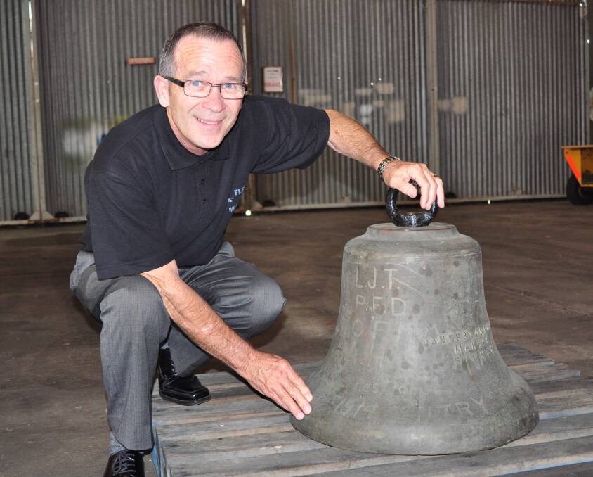 
HISTORY: Fleet Air Arm Museum manager Terry Hetherington with the historic HMAS Creswell bell which clearly shows the initials including LJT that belong to Lovel John Towers.