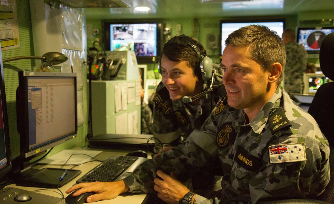 Leading Seaman Electronic Warfare operator Damien Jennings and Seaman Electronic Warfare operator Matthew McPherson manning the console in the operations room onboard HMAS Canberra during a Nulka trial as part of Exercise Ocean Explorer.