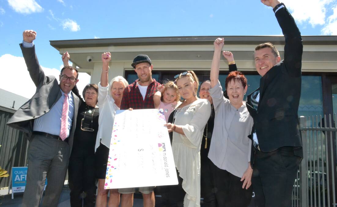 YOU BEAUTY: Andrew and Hayley Dolphin with their four-year-old daughter Ella celebrate their $235,000 prize win with staff from McDonald Jones Homes at South Nowra.