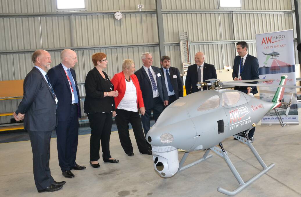 Minister for Defence Senator Marise Payne at Air Affairs at the Albatross Aviation Technology Park with CEO Chris Sievers (far left) and  Leonardo Helicopters engineer Roberto Pretolani (far right).