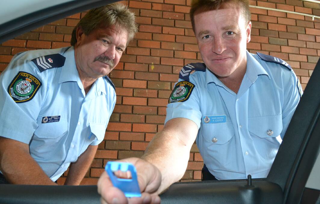 TESTS TO INCREASE: Commanding officer of Shoalhaven Highway Patrol, Sergeant Mick Tebbutt (left) and Leading Senior Constable Adam Cooper with the mobile drug testing equipment. Mobile drug tests are set to increase after the state government launched a drug driving campaign.