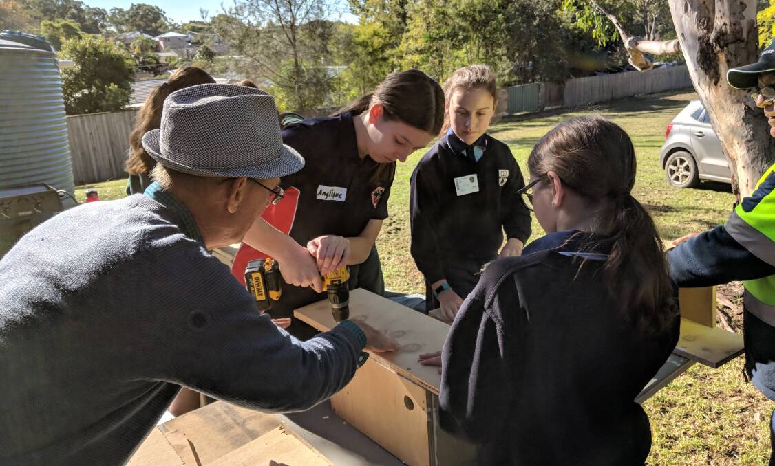Students at the Shoalhaven Intrepid Landcare Expo building nestboxes for sugar glider habitat.