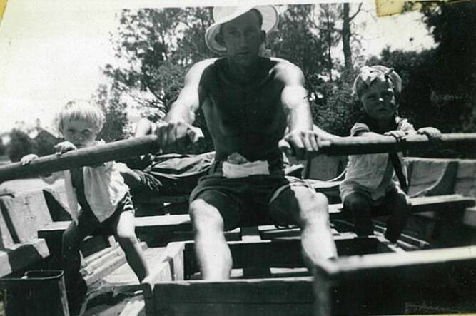Pat and Bob in the rowboat with their father George Smith in 1947.