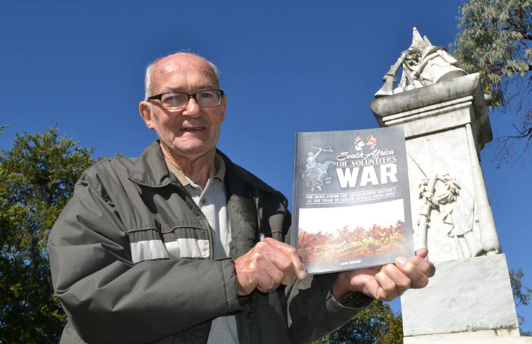 The late Keith Paterson shows off his last publication on the Boer War near the Nowra memeorial.
