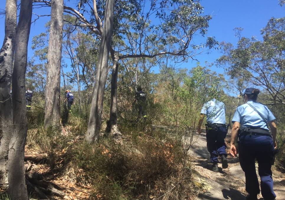 Emergency services trekking into the Bomaderry Creek walking Track to recover the injured woman. Photo: Hayley Warden