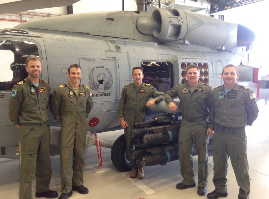 AUSSIE MADE: Lieutenant Commander Eugene Cleary and Lieutenants Chris Prescott and Geoff Winter, Petty Officer  Colin McCallum and Leading Seaman  McGreal are the first Australian trained  MH-60R Seahawk helicopter aircrew. 