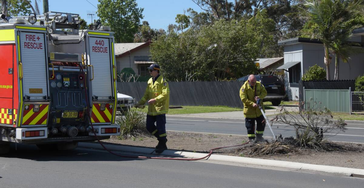 Fire and Rescue NSW Shoalhaven crews extinguish the fire on the median strip on the Princes Highway at Bomaderry.