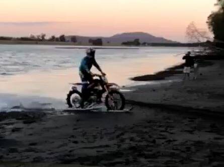 Daredevil Robbie Maddison returns to Terra firma after tackling the Shoalhaven River on a motorbike. Image: Brett Austin