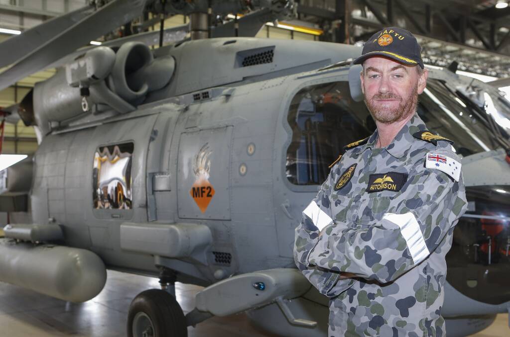 BUSY TIME: Officer in charge of Navy's Aircraft Maintenance and Flight Trials Unit (AMAFTU), Commander David Hutchinson, in front of a MH-60R Seahawk Romeo at 725 Squadron. Photo: Sarah Ebsworth