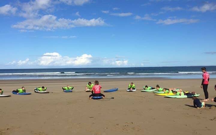 GREAT TIME: Veterans taking part in a try surfing day event at Gerroa with Gerringong Surf School owner, Rusty Moran. 