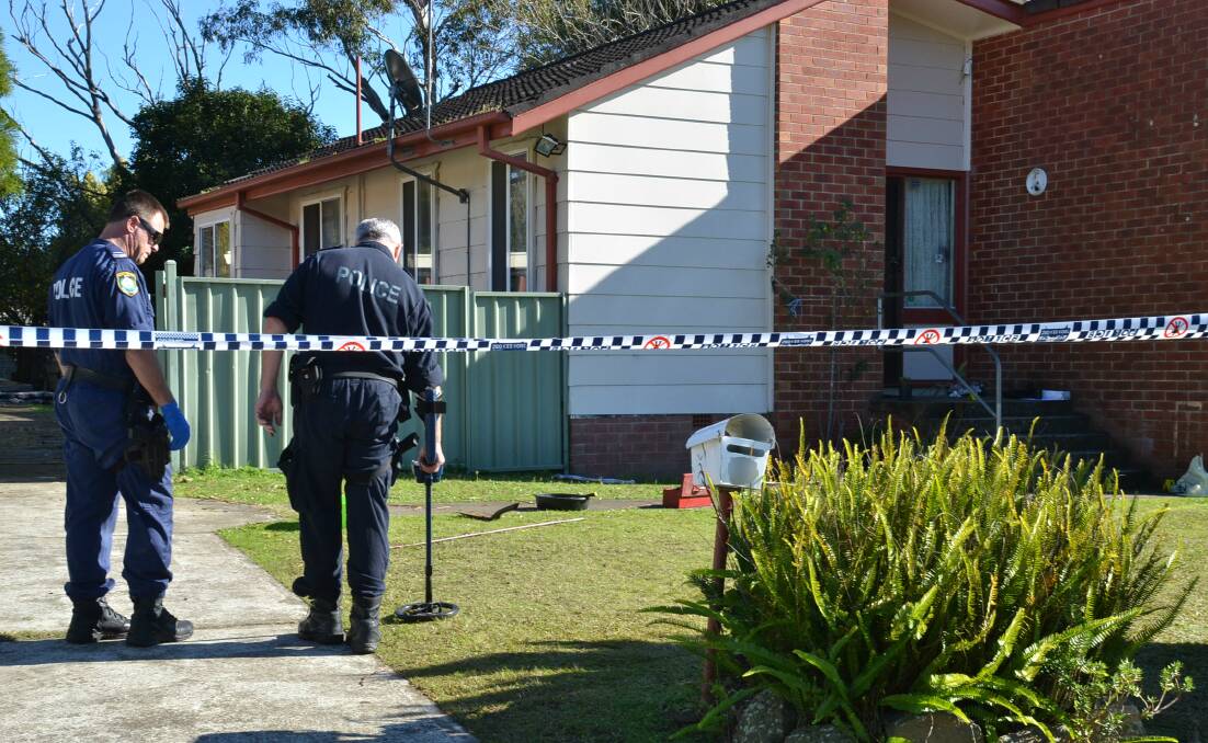 CRIME SCENE: Police search for evidence outside the home in North Nowra.
