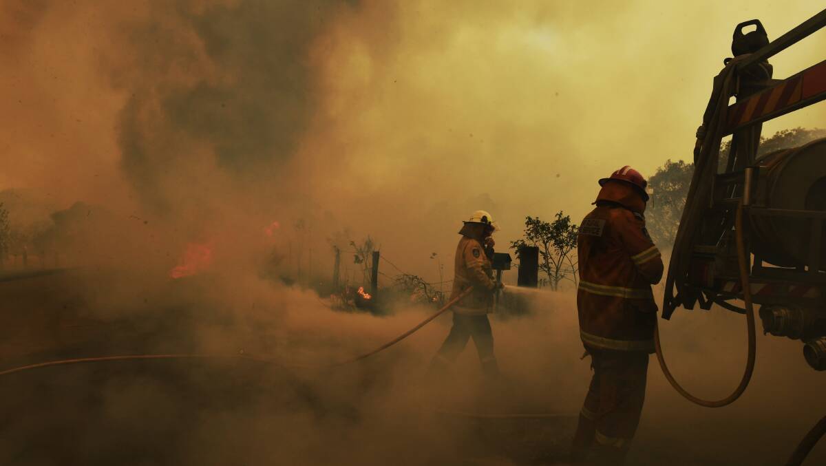 Spot fires threaten to overwhelm RFS volunteer firefighters at the Hillville on Wednesday. Picture: Nick Moir