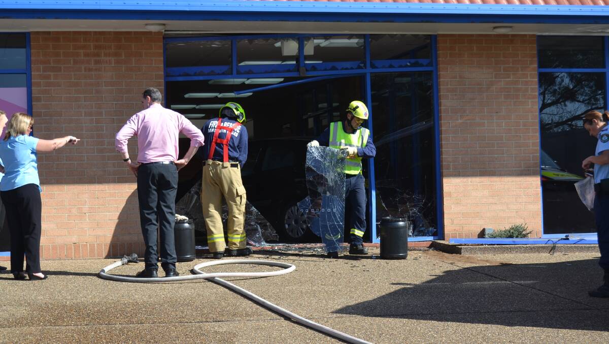 Fire and Rescue NSW staff remove debris. Picture: Sam Strong.