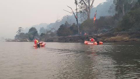 SMOKEY SCENES: Lifesavers patrol the Bega River on March 18. Picture: Donald Hay.
