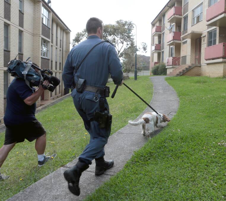 SEARCHING: A drug detection dog is led into the Mangerton unit complex. Picture: Adam McLean