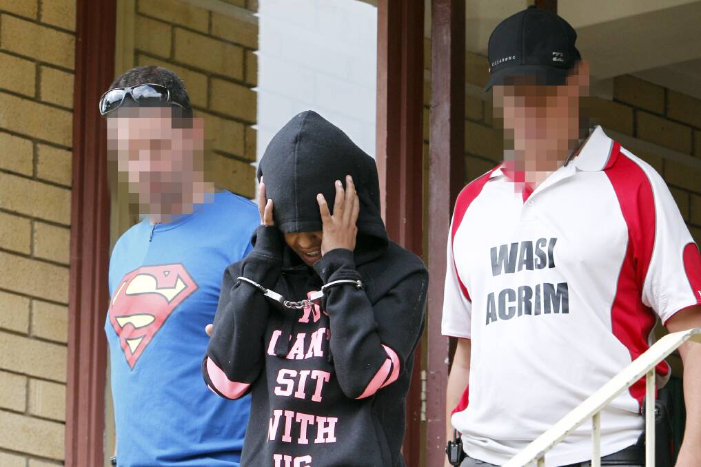 Police attached to Wollongong's drug investigation unit lead a woman from a unit complex on Johansen Street, Mangerton, Tuesday morning. Picture: Adam McLean