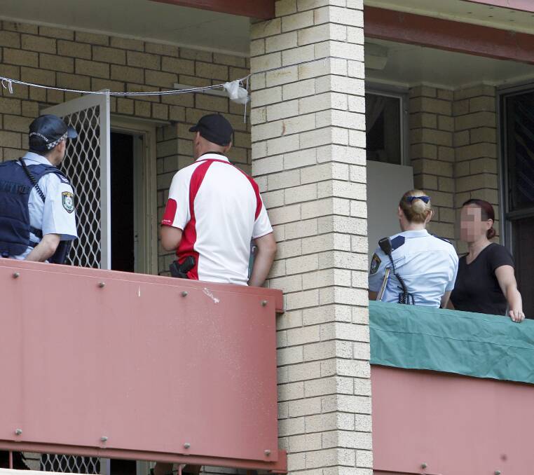 Ice arrest: Police converge on the balcony of an upstairs Mangerton unit, Tuesday morning. Picture: Adam McLean