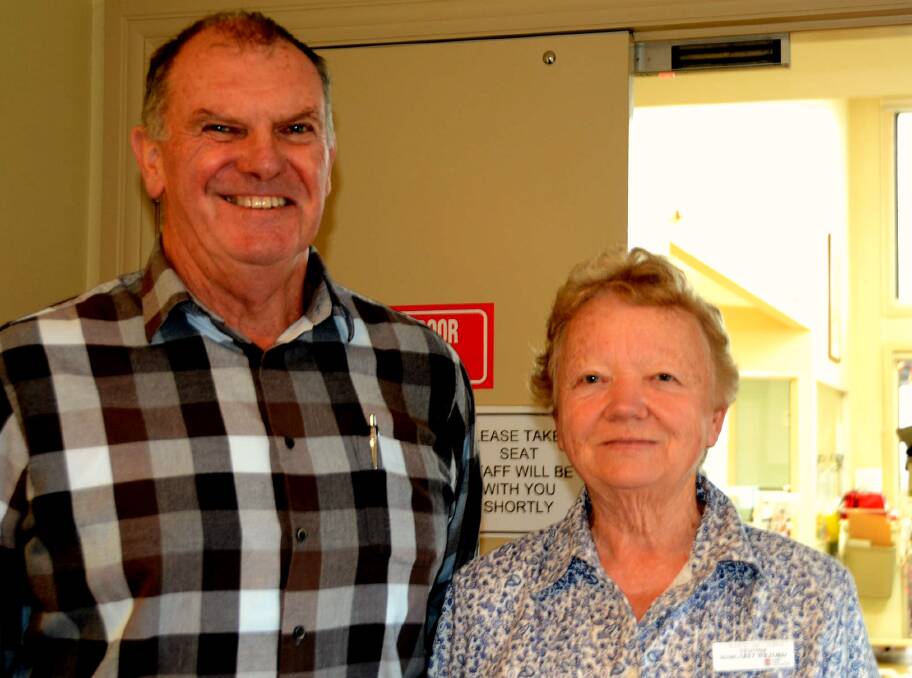 TEE OFF: Appeal volunteers Peter Still and Marg Wilford cross their fingers ahead of the team golf day that will help pay for the new palliative care unit.
