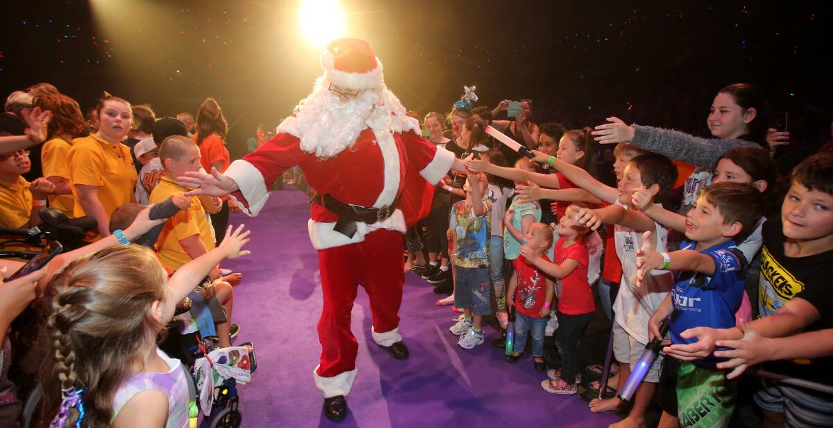 ROCK STAR RECEPTION: Santa Claus traded the cold climate of the North Pole for Wollongong on Thursday to thrill his fans.