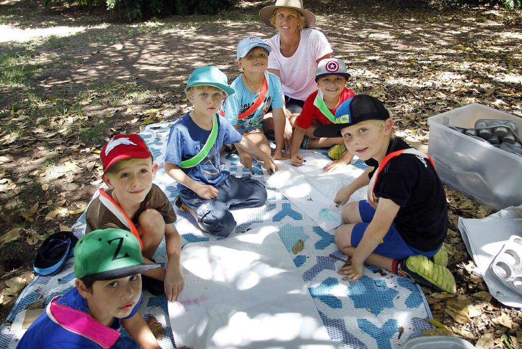 CHILDS PLAY: Educator Amanda Lloyd making leaf rubbings of environmental materials with children in the Outdoor Connections holiday activity program in Kiama at the Bonaira Reserve. Picture: Sylvia Liber